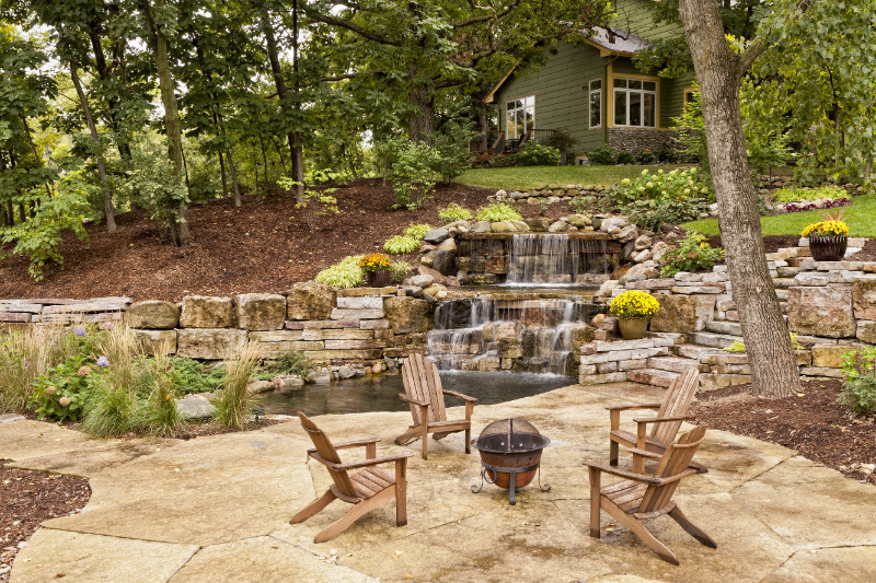 a wooden bench sitting next to a tree - Spruce up your backyard with these 7 outdoor amenities